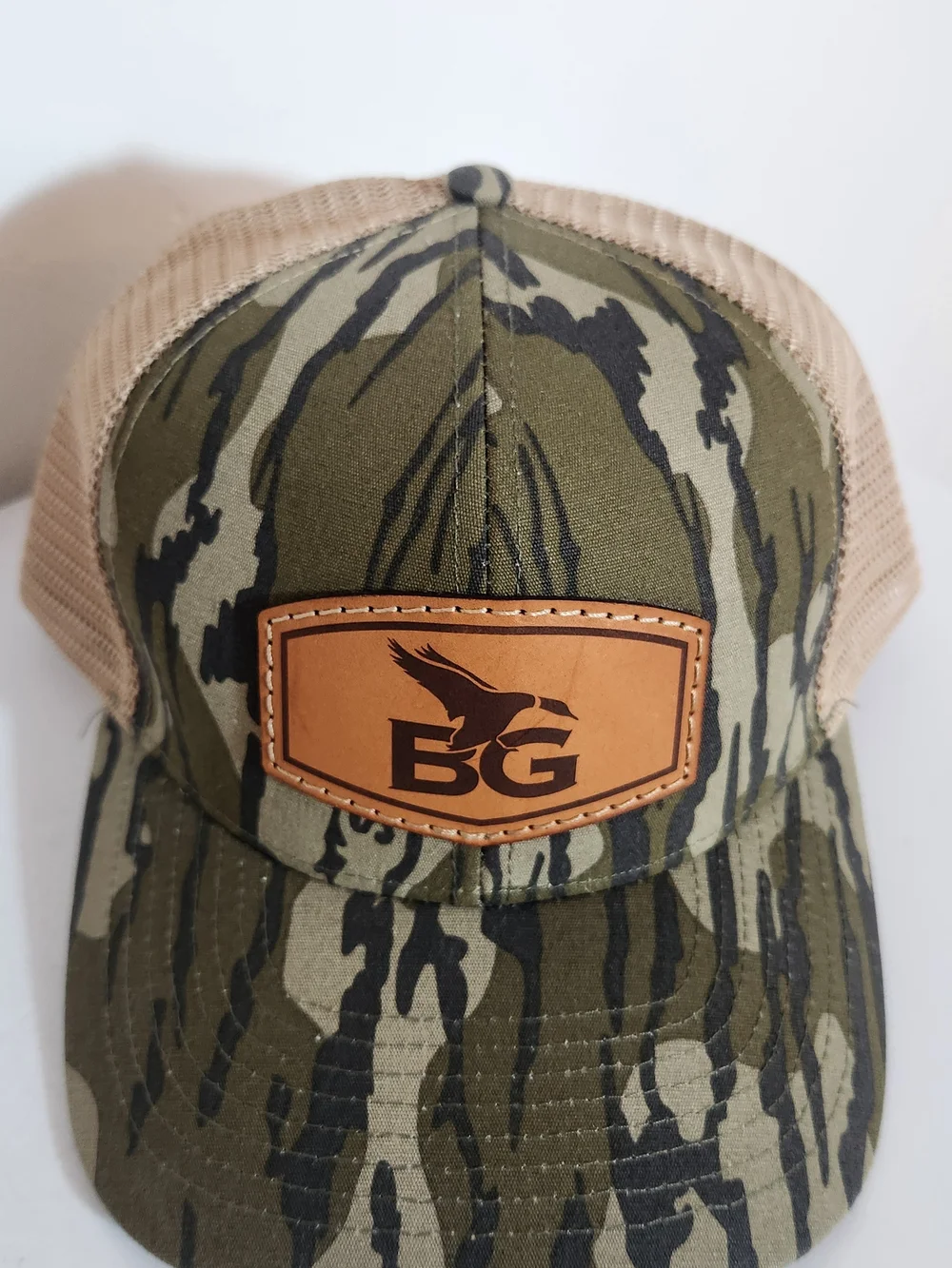 Lost Hat Co Buck Gardner Bottomland Camo Leather Patch Trucker Hat